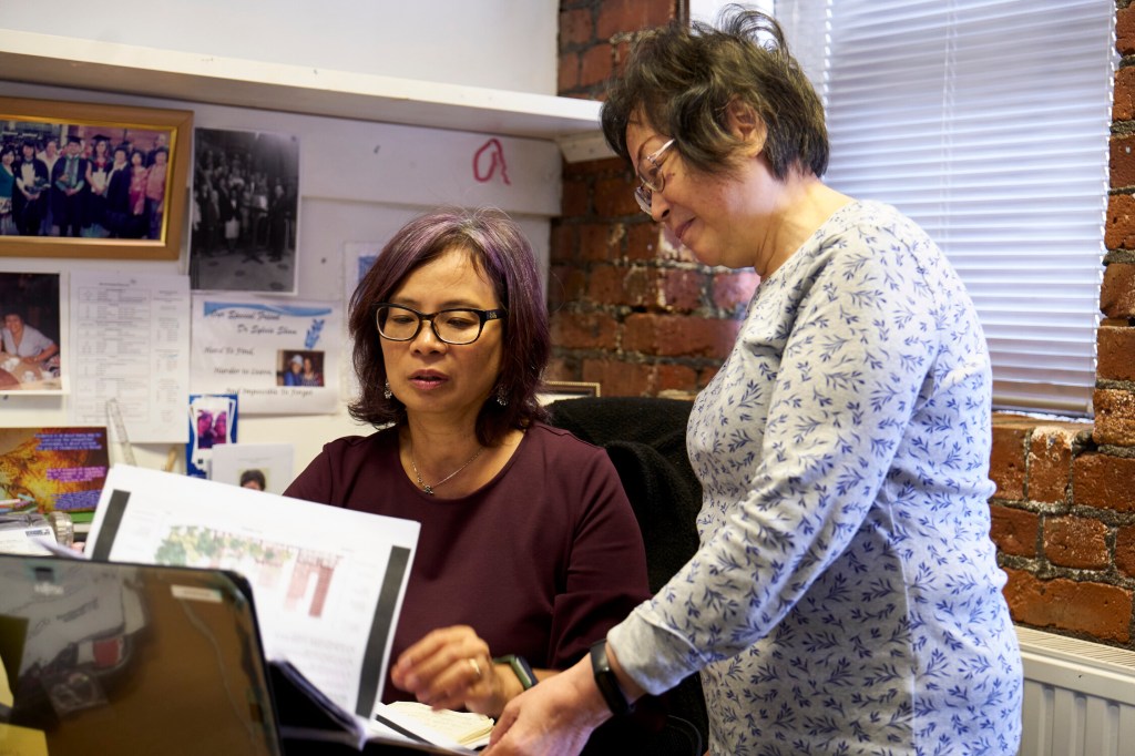 Two older women collaborating in an office setting
