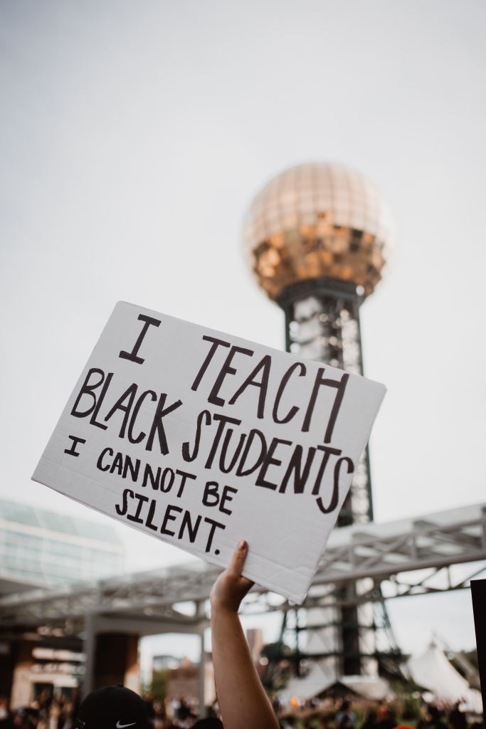 A placard reading 'I teach Black students I cannot be silent'
