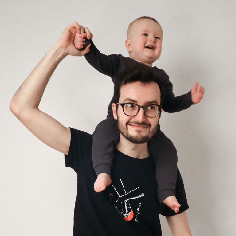 Sacha and his young child enjoy a fun moment playing together.