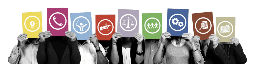 9 people standing in a line shoulder to shoulder, hold brightly coloured card in front of their faces. Each has the symbol of one of the 9 Belbin team roles on it.