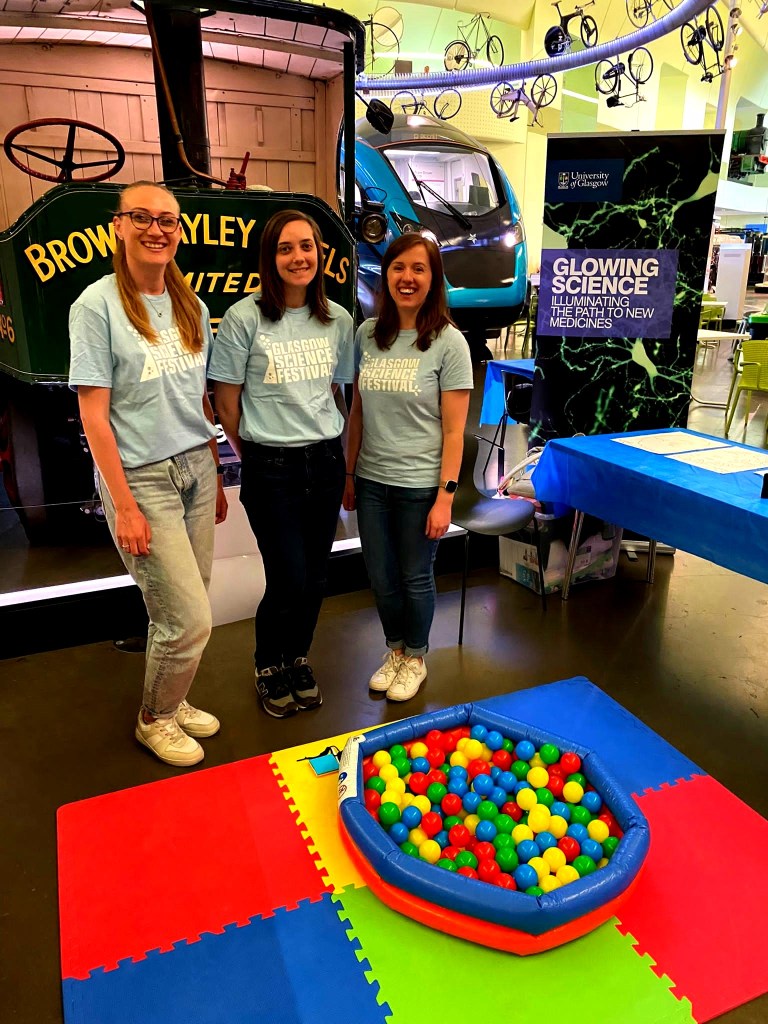 Beth and two colleagues at the Glowing Science event