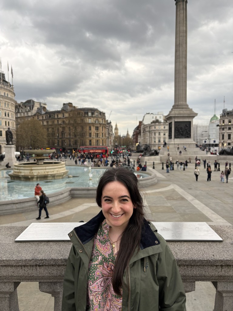 A photo of Dila standing by Nelson's Column in Trafalgar Square